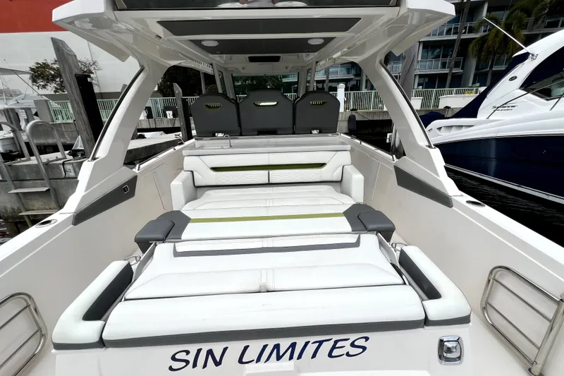 Slide: The Image of 2019 Tiara Sport 34 LS luxury boat with spacious seating at a marina. - 10