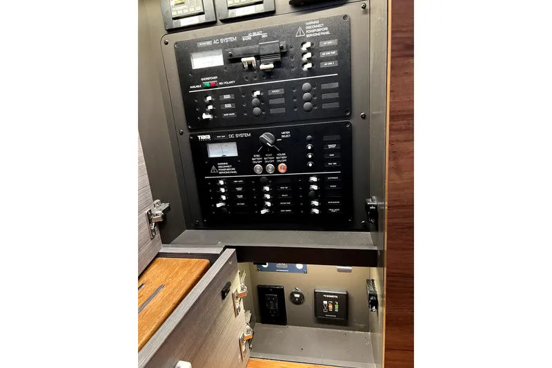 Slide: The Image of Electrical control panel of a 2019 Tiara Sport 34 LS boat, featuring AC and DC systems. - 18
