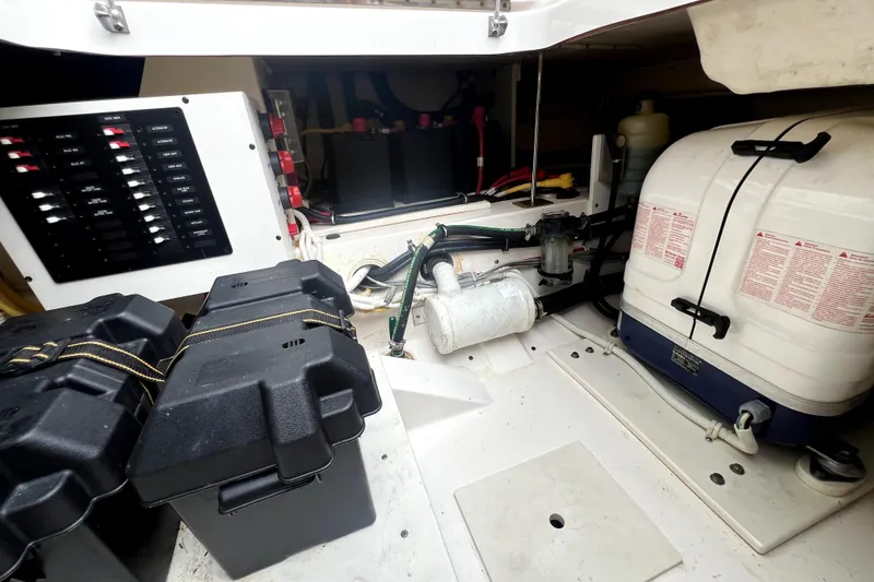 Slide: The Image of 2019 Tiara Sport 34 LS engine compartment with battery boxes and electrical panel. - 22