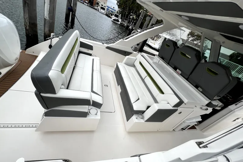 Slide: The Image of 2019 Tiara Sport 34 LS boat interior with luxurious seating and waterfront view. - 7