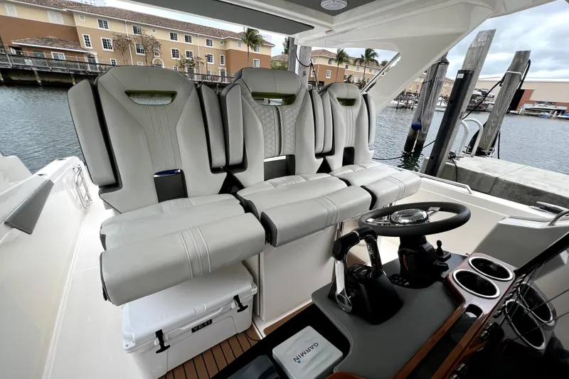 Slide: The Image of 2019 Tiara Sport 34 LS boat interior with luxurious seating and modern helm controls. - 8