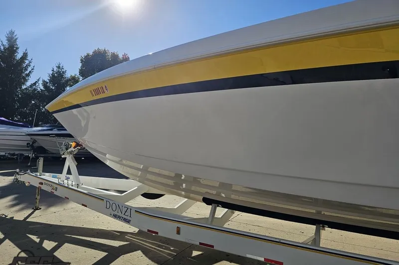 Slide: The Image of 2003 Donzi 38 ZX boat on trailer under bright sunlight. - 22