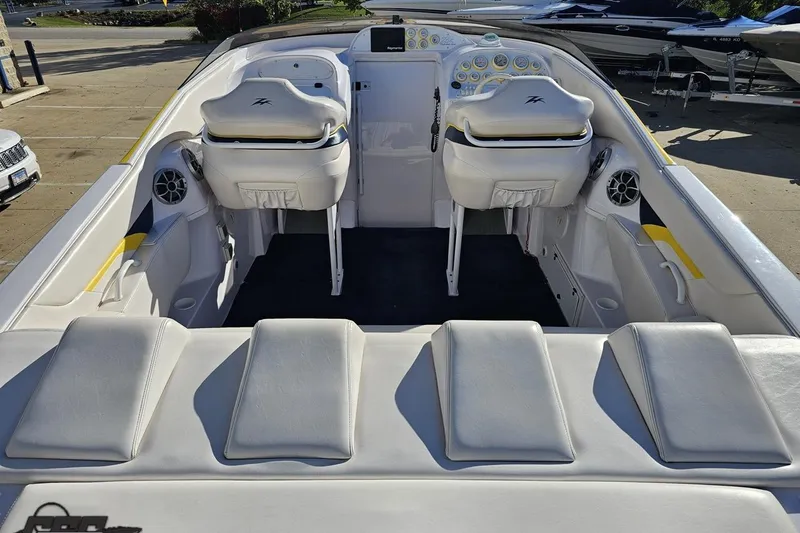Slide: The Image of 2003 Donzi 38 ZX boat interior with white seating and dashboard controls. - 34
