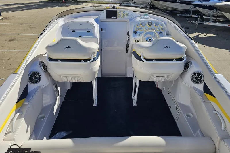 Slide: The Image of 2003 Donzi 38 ZX boat interior with white seating and dashboard controls. - 35