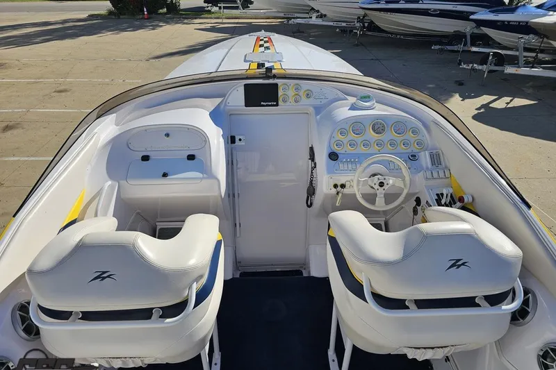 Slide: The Image of 2003 Donzi 38 ZX boat cockpit with white seating and detailed dashboard controls. - 36