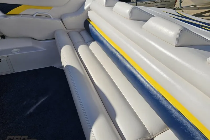 Slide: The Image of 2003 Donzi 38 ZX boat interior with white, blue, and yellow upholstery. - 38