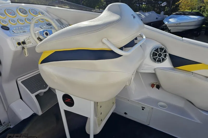 Slide: The Image of 2003 Donzi 38 ZX boat interior with white and yellow seating, dashboard, and steering wheel. - 40