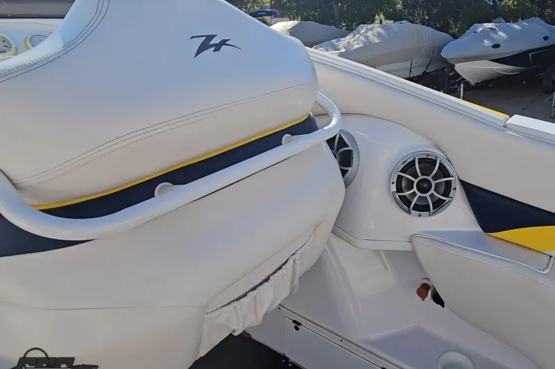 Slide: The Image of Interior of a 2003 Donzi 38 ZX boat, featuring white seating and speaker system. - 41