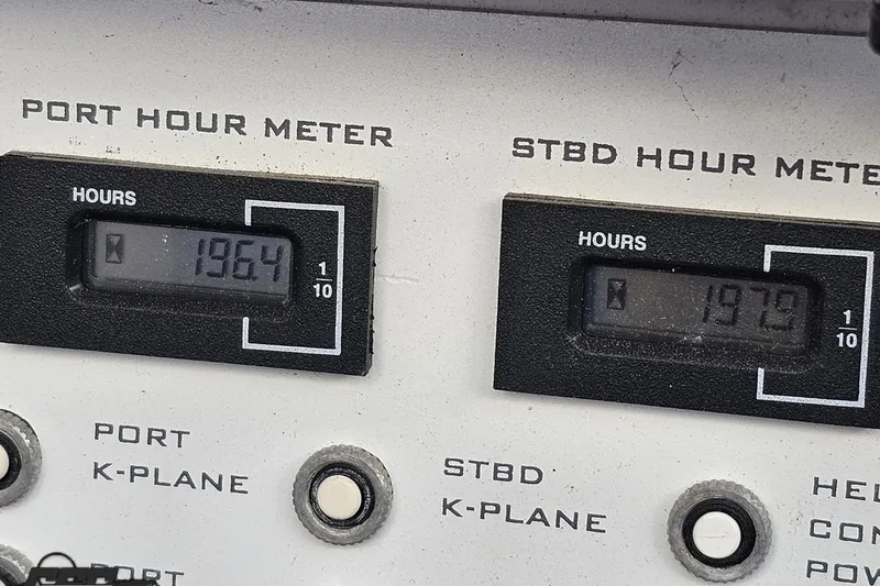 Slide: The Image of Hour meters on a 2003 Donzi 38 ZX boat dashboard, showing 1964 and 1979 hours. - 43