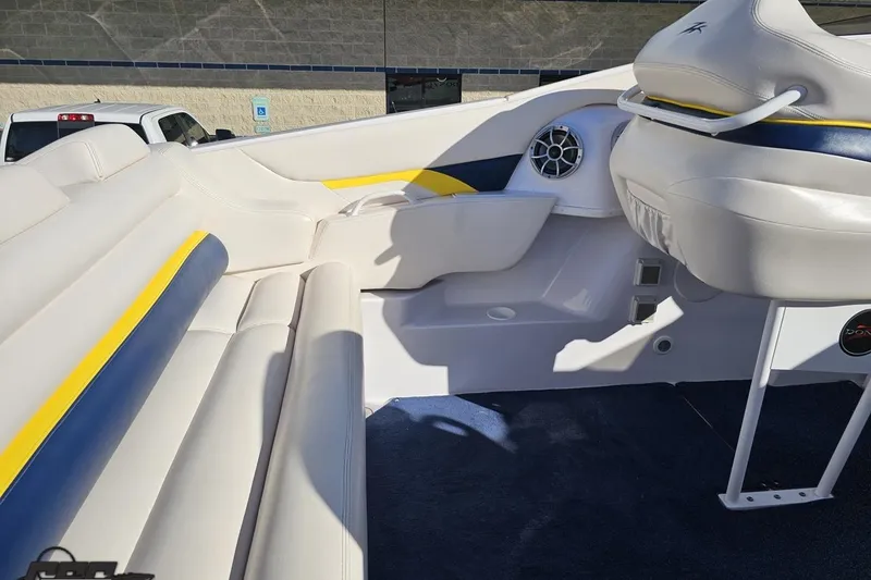 Slide: The Image of 2003 Donzi 38 ZX boat interior with white and blue seating, speaker, and steering area. - 44
