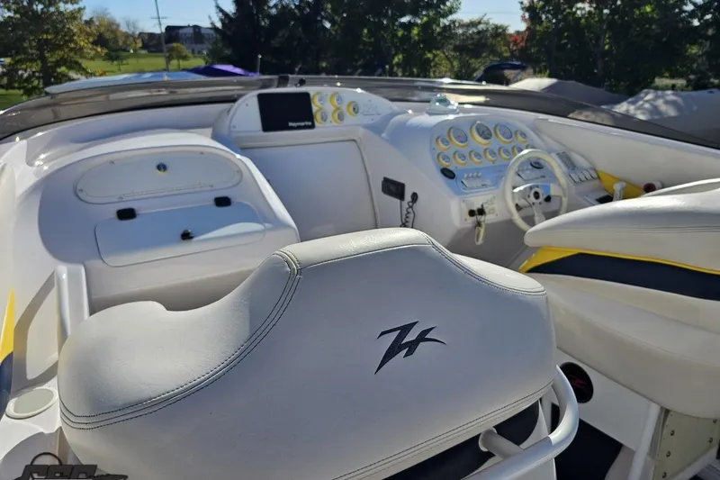 Slide: The Image of 2003 Donzi 38 ZX boat interior with white seating and detailed dashboard controls. - 47