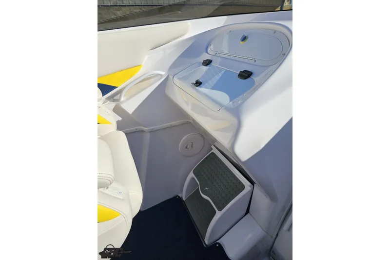 Slide: The Image of 2003 Donzi 38 ZX boat interior with white and yellow seating, storage compartment. - 49