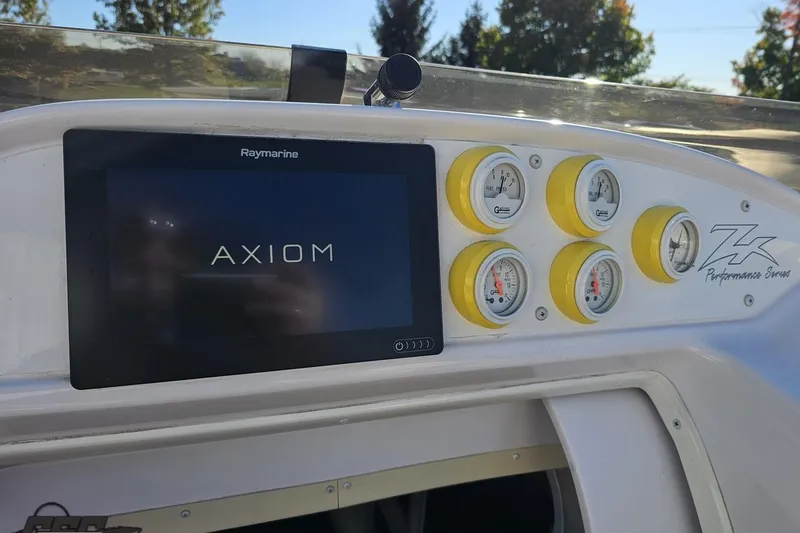 Slide: The Image of Dashboard of a 2003 Donzi 38 ZX boat with Raymarine Axiom display and gauges. - 55