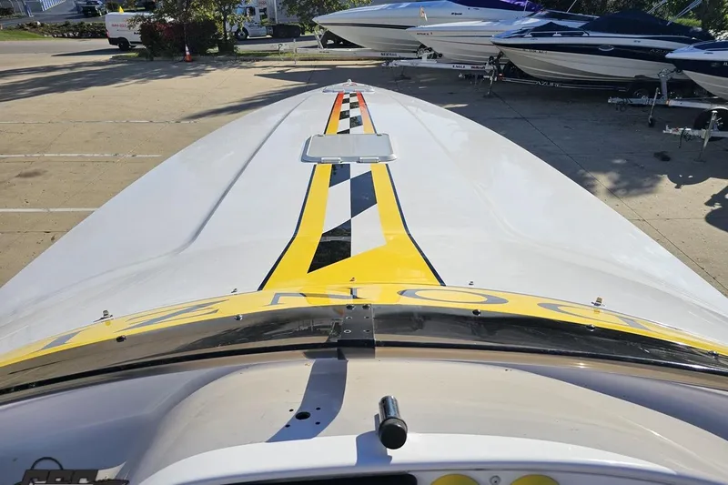 Slide: The Image of 2003 Donzi 38 ZX boat with yellow and black racing stripes on deck. - 56