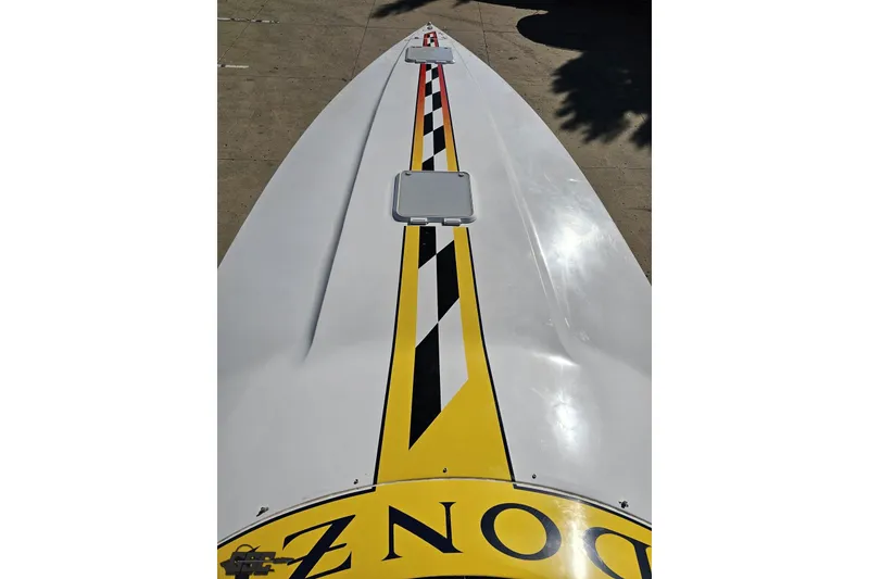 Slide: The Image of 2003 Donzi 38 ZX boat with yellow and black racing stripes on deck. - 57