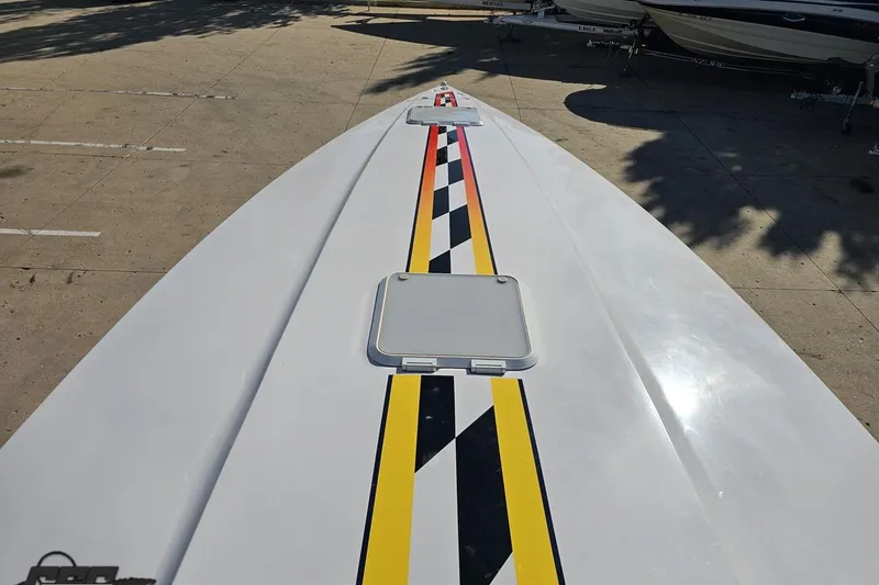 Slide: The Image of 2003 Donzi 38 ZX boat with vibrant racing stripes on deck. - 58