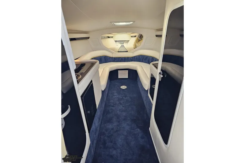 Slide: The Image of Interior of a 2003 Donzi 38 ZX boat with blue carpet and white seating. - 63
