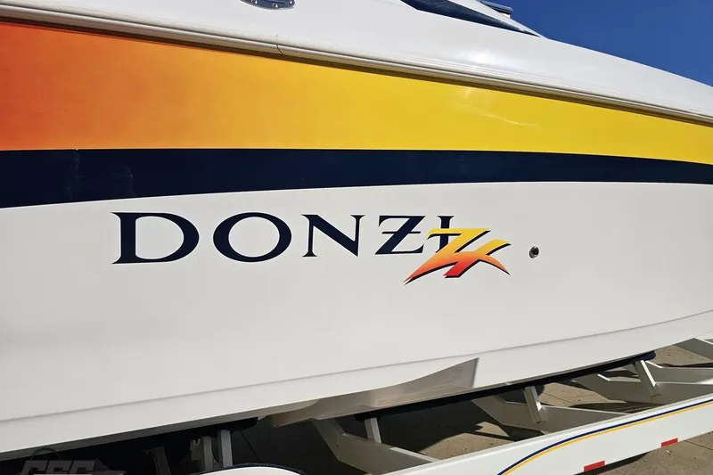 Slide: The Image of 2003 Donzi 38 ZX boat with vibrant yellow and orange detailing. - 7