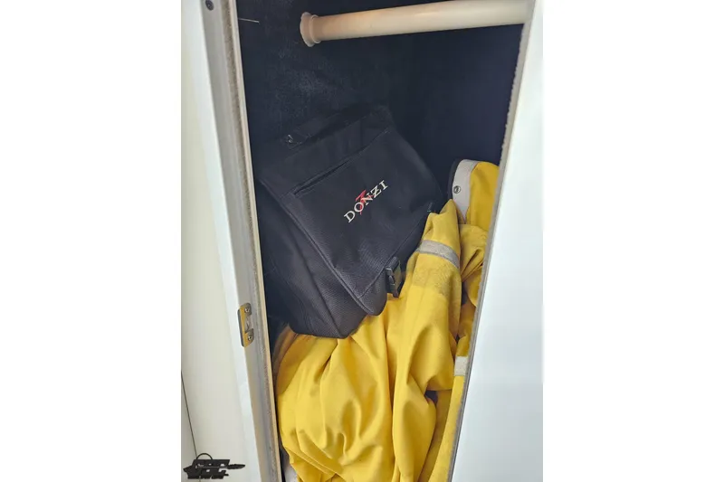 Slide: The Image of Storage compartment with Donzi bag and yellow jacket, 2003 Donzi 38 ZX boat. - 70