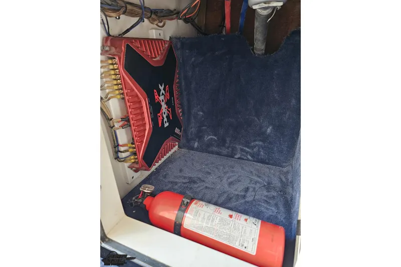 Slide: The Image of 2003 Donzi 38 ZX interior with amplifier and fire extinguisher. - 76