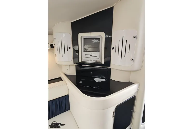 Slide: The Image of 2003 Donzi 38 ZX cabin interior with built-in entertainment system and sleek cabinetry. - 83