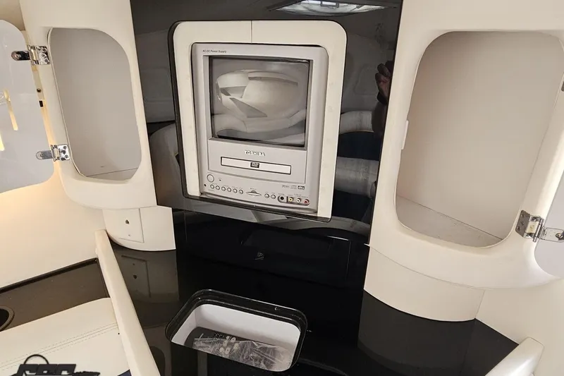 Slide: The Image of 2003 Donzi 38 ZX interior with built-in Toshiba TV and storage compartments. - 84