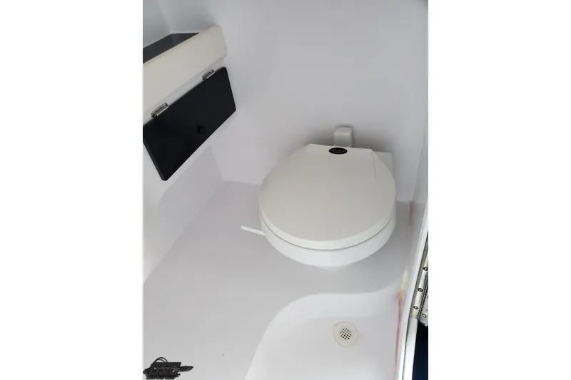 Slide: The Image of 2003 Donzi 38 ZX boat interior with a compact marine toilet. - 88