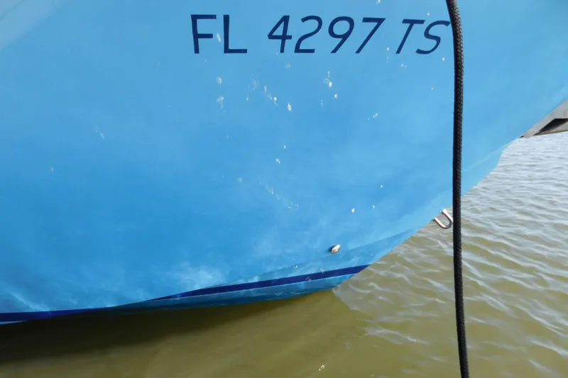 Slide: The Image of 2024 Pursuit DC 326 Dual Console boat with registration FL 4297 TS on water. - 11