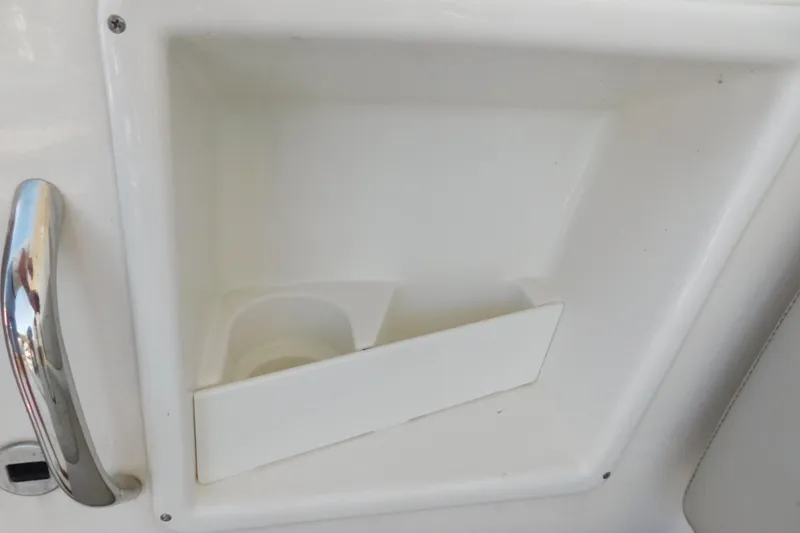 Slide: The Image of 2024 Pursuit DC 326 Dual Console cup holder and handle detail. - 23