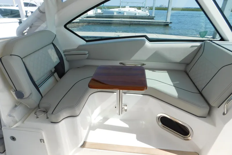 Slide: The Image of 2024 Pursuit DC 326 Dual Console interior with elegant seating and wooden table. - 30