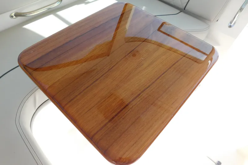 Slide: The Image of Polished wooden table on 2024 Pursuit DC 326 Dual Console boat. - 31