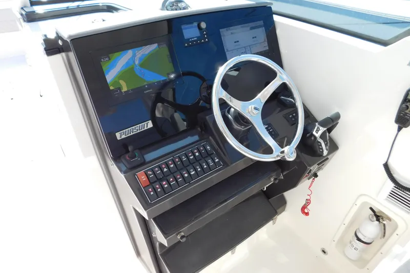Slide: The Image of 2024 Pursuit DC 326 Dual Console helm with navigation display and steering wheel. - 32