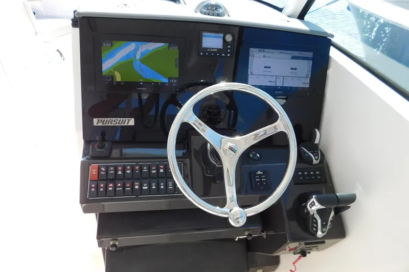 Slide: The Image of 2024 Pursuit DC 326 Dual Console dashboard with navigation screens and controls. - 35