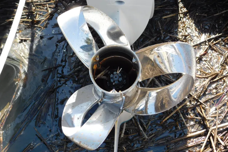 Slide: The Image of 2024 Pursuit DC 326 Dual Console boat propeller in water with debris. - 4