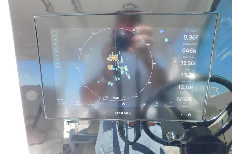 Slide: The Image of Garmin navigation display on 2024 Pursuit DC 326 Dual Console boat dashboard. - 42