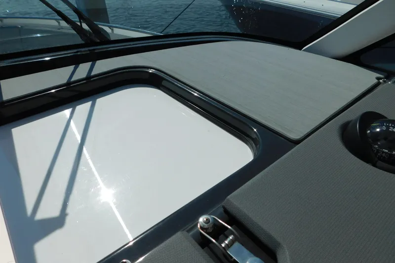 Slide: The Image of 2024 Pursuit DC 326 Dual Console dashboard with compass and sleek design. - 44