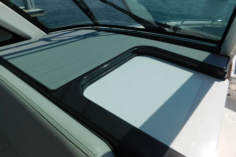 Slide: The Image of 2024 Pursuit DC 326 Dual Console boat dashboard with sleek design and windshield. - 45