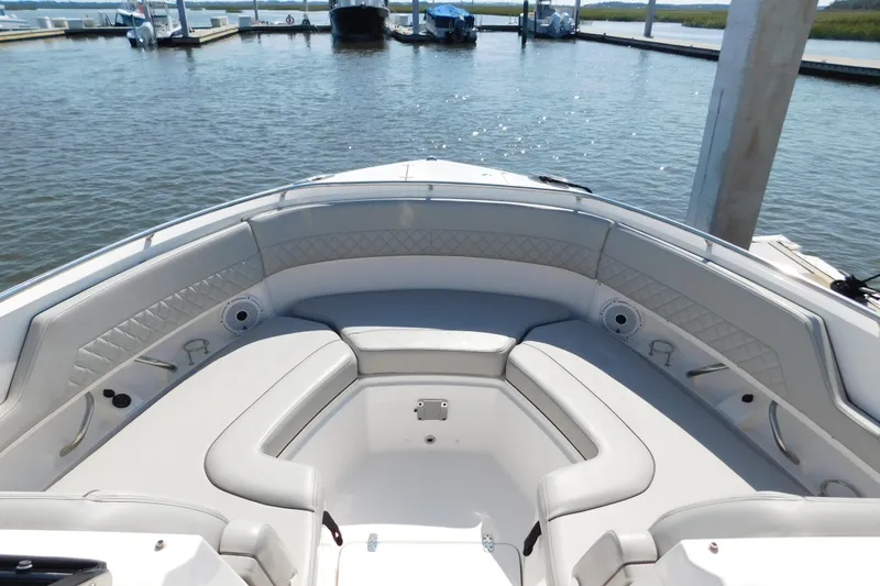 Slide: The Image of 2024 Pursuit DC 326 Dual Console boat interior with luxurious seating at marina. - 48