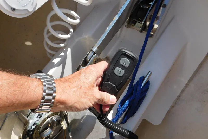 Slide: The Image of Hand operating controls on 2024 Pursuit DC 326 Dual Console boat. - 56