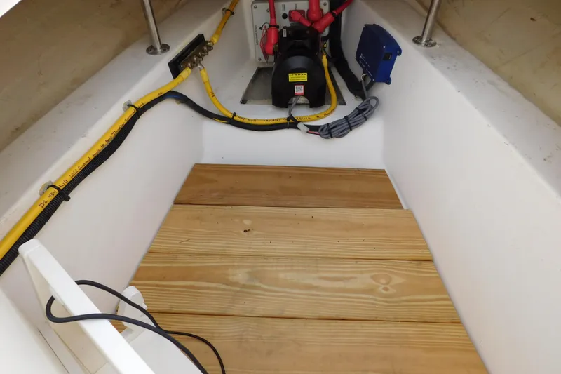 Slide: The Image of 2024 Pursuit DC 326 Dual Console boat interior with wooden flooring and electrical components. - 61