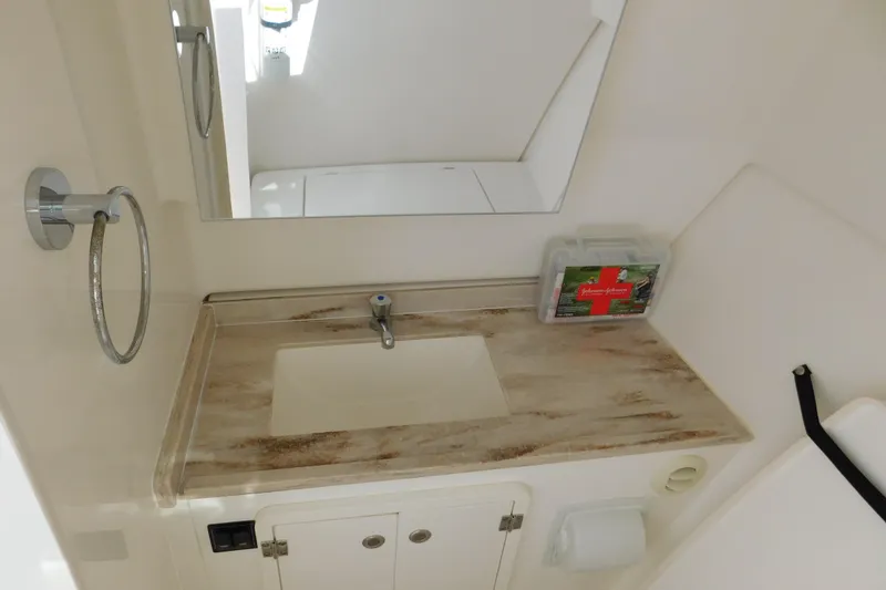 Slide: The Image of 2024 Pursuit DC 326 Dual Console bathroom with sink, mirror, and first aid kit. - 65