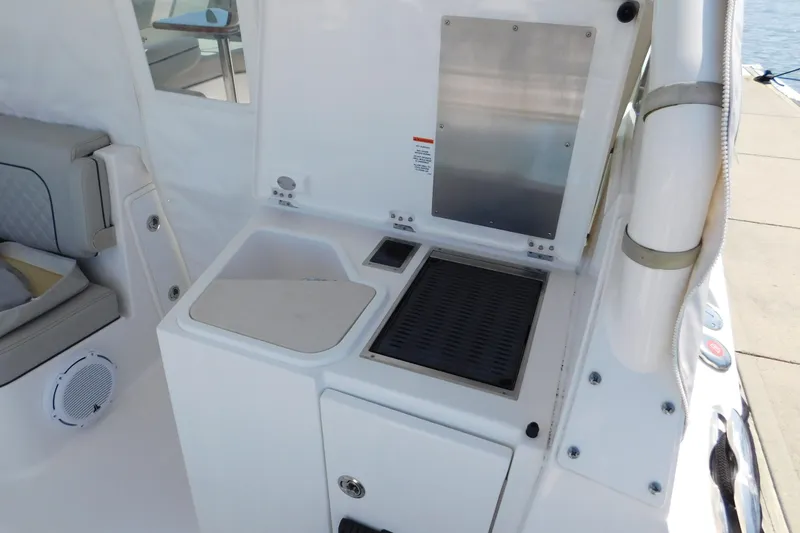 Slide: The Image of 2024 Pursuit DC 326 Dual Console boat interior with seating and utility area. - 92