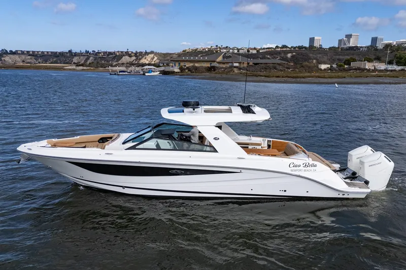 Slide: The Image of 2023 Sea Ray SLX 400 Outboard boat cruising near Newport Beach, clear skies. - 1