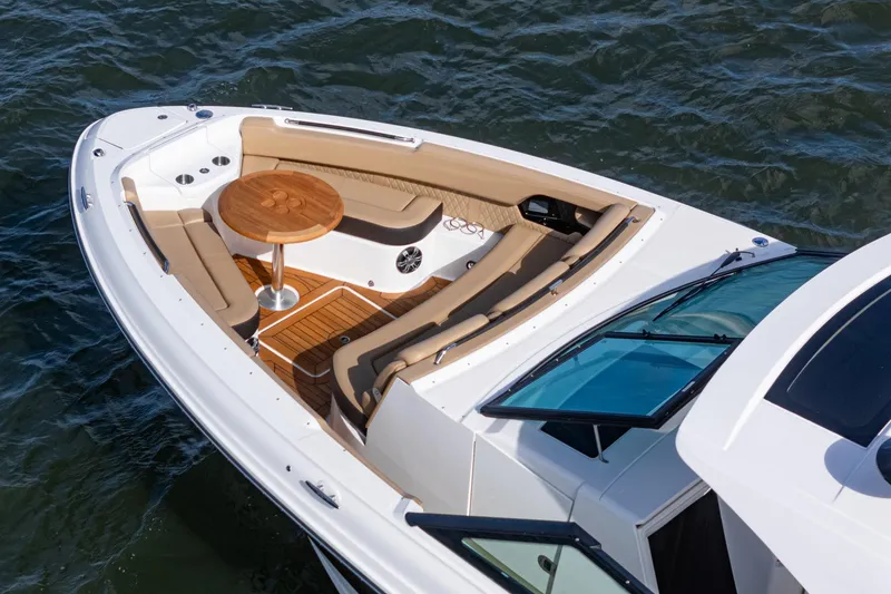 Slide: The Image of 2023 Sea Ray SLX 400 Outboard boat with luxurious seating and wooden table on water. - 11