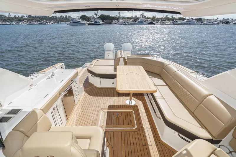 Slide: The Image of 2023 Sea Ray SLX 400 Outboard luxury boat interior with spacious seating and scenic water view. - 15