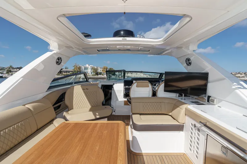 Slide: The Image of 2023 Sea Ray SLX 400 Outboard interior with luxurious seating and modern amenities. - 21
