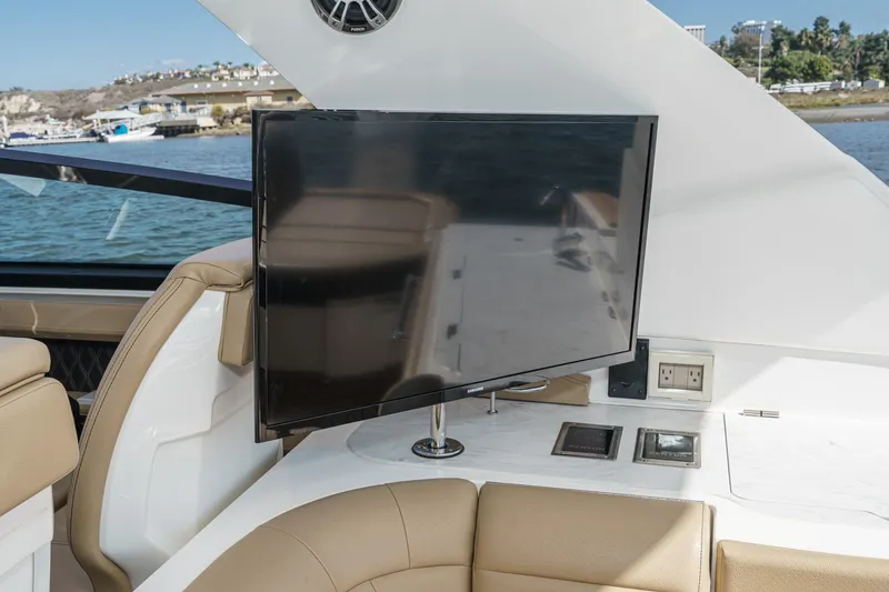 Slide: The Image of 2023 Sea Ray SLX 400 Outboard interior with TV and luxurious seating. - 22