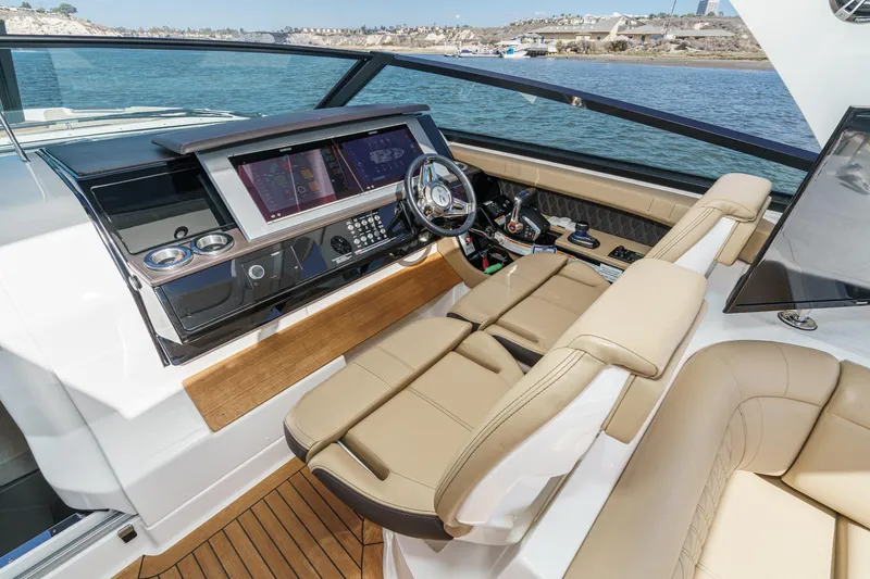 Slide: The Image of 2023 Sea Ray SLX 400 Outboard helm with luxurious seating and advanced navigation controls. - 23