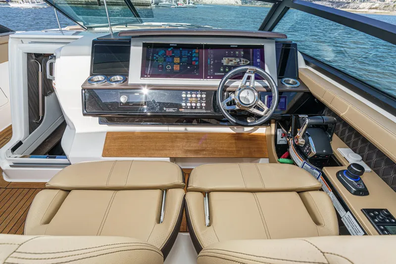 Slide: The Image of 2023 Sea Ray SLX 400 Outboard helm with modern controls and luxurious seating. - 24