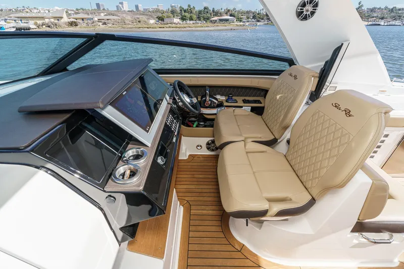 Slide: The Image of 2023 Sea Ray SLX 400 Outboard helm with dual seats and modern dashboard. - 25